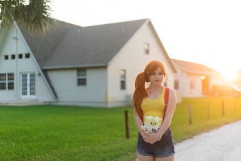 woman standing near white house during daytime