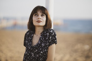 Woman Standing Near White Post