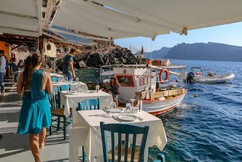 Woman Standing Near White Table and Yacht