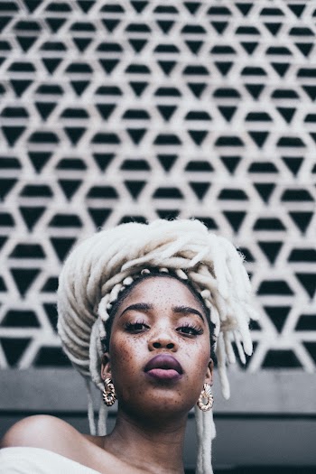 Woman Standing Near White Wall
