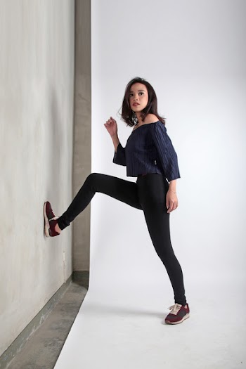 Woman Standing Near White Wall