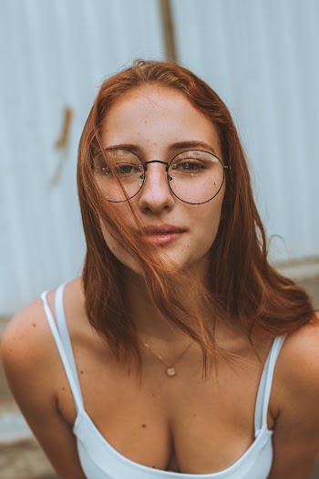 Woman Standing Near White Wall