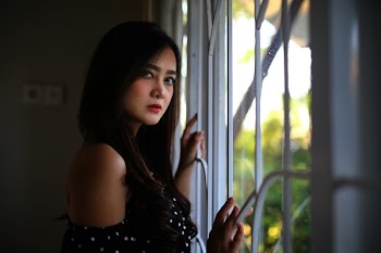 Woman Standing Near Window
