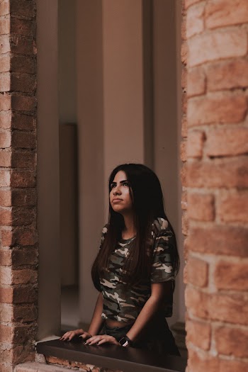 Woman Standing Near Window Panel Looking Up