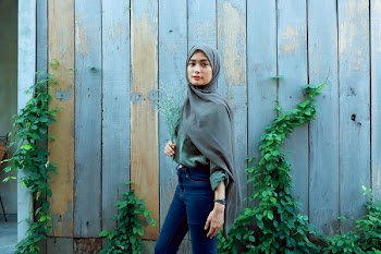 Woman Standing Near Wooden Wall
