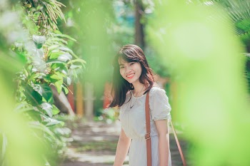 Woman Standing Nearby Green Leafed Plant