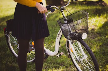 Woman Standing Next to White City Bike
