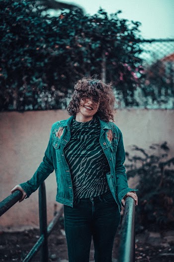Woman Standing on a Metal Bridge