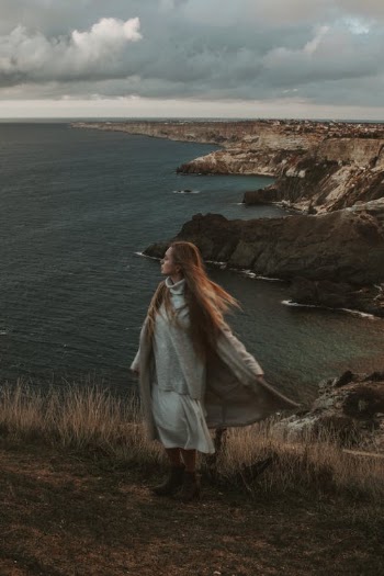 Woman Standing on a Rocky Coastline  · Free Stock Photo