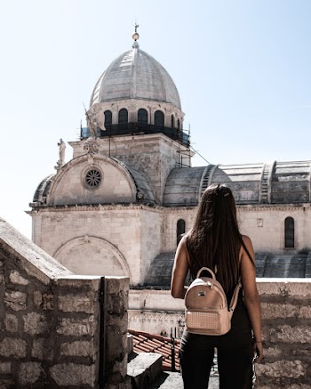 Woman Standing On A Rooftop With The View Of The Church Dome