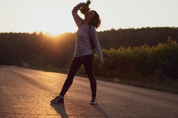 Woman Standing on Asphalt Road