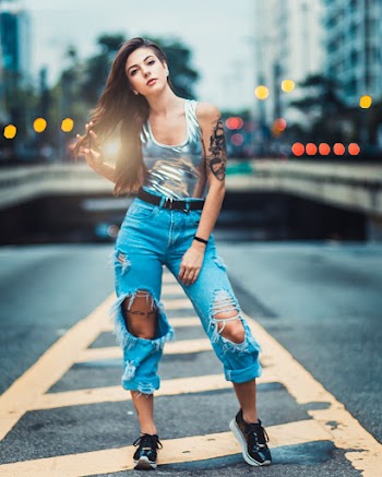 Woman Standing on Asphalt Road
