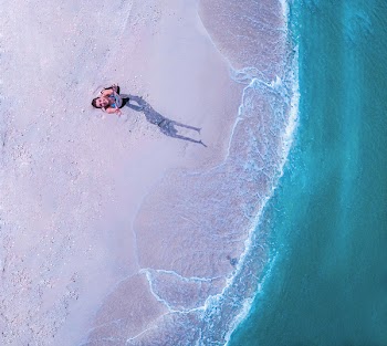 Woman Standing on Beach Line