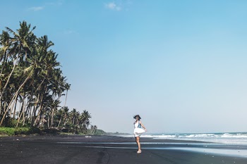Woman Standing on Beach Shore