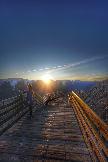 Woman Standing on Bridge during Golden Hour