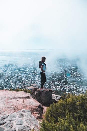 Woman Standing on Brown Rocky Mountain