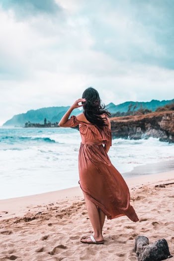 woman standing on brown sand