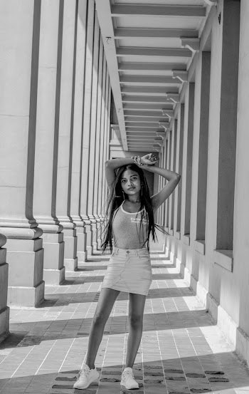 Woman Standing on Building Corridor