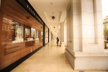 Woman Standing on Building Pathway