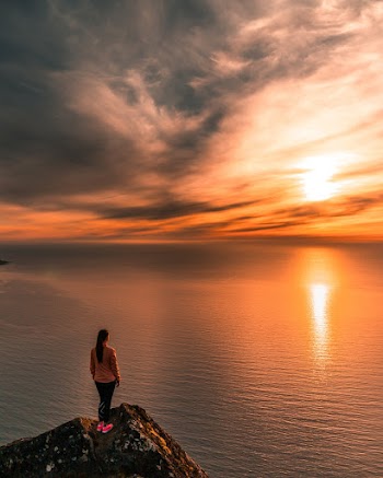 Woman Standing On Cliff