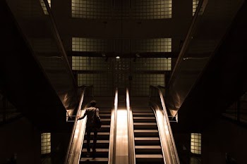 woman standing on escalator