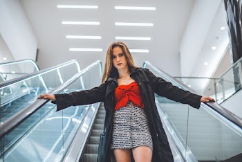 Woman Standing On Escalator