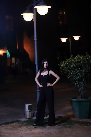 Woman Standing on Front of Black Road Lamp