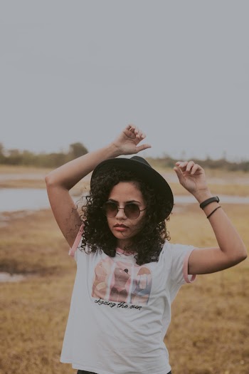 Woman Standing on Grass Field