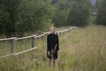 Woman Standing on Grass Field