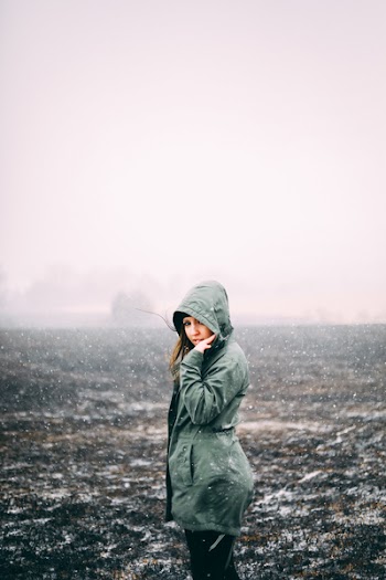 Woman Standing on Grass Field