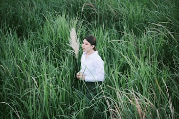 Woman Standing on Grass Field