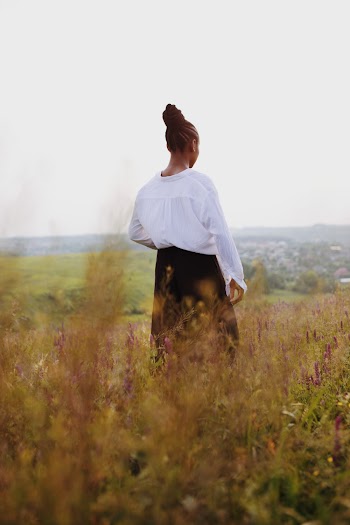 Woman Standing on Grass Field