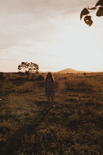 Woman Standing on Grass Field