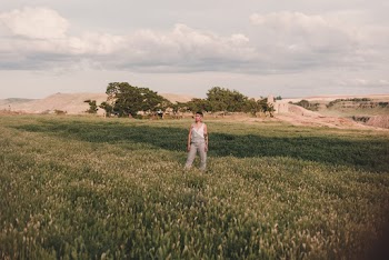 Woman Standing on Grass Field