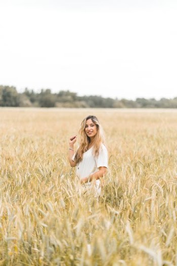 woman standing on grass field during daytime