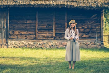 Woman Standing on Grass Field Holding Dslr Camera