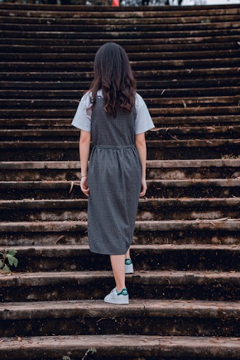 Woman Standing on Gray Concrete Stairs