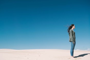 woman standing on gray sand