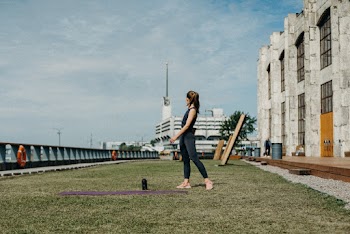 Woman Standing on Green Grass
