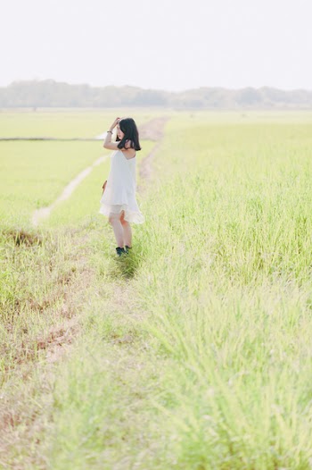 Woman Standing on Green Grass Field