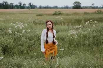 woman standing on green grass field