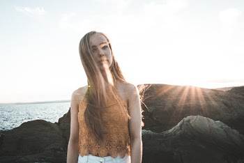 Woman Standing on Grey Rock Formation