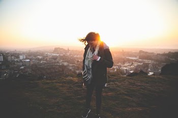 woman standing on ground during golden hour