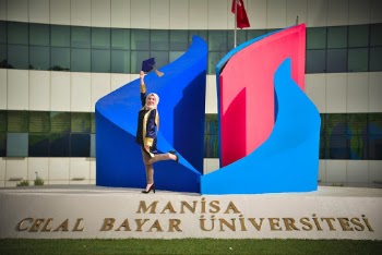 Woman Standing on Manisa Celal Bayar Universitesi Signage