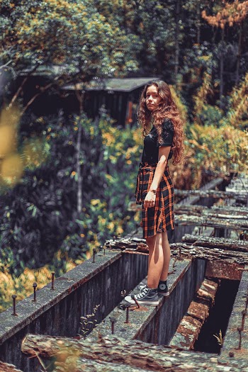 Woman Standing on Metal Beam
