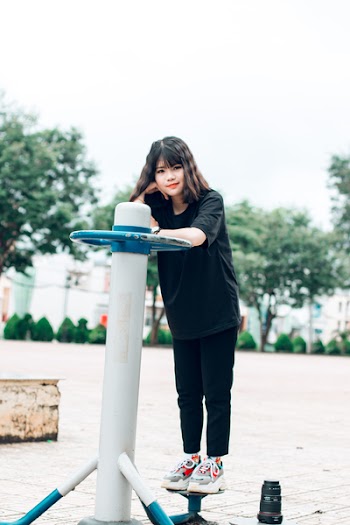 Woman Standing on Metal Pipe