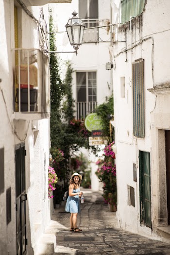 Woman Standing on Pathway Surrounded by Houses