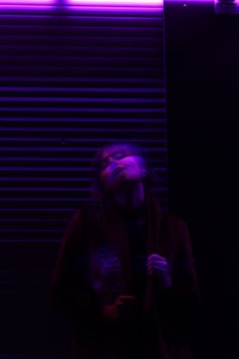 woman standing on purple lighted room