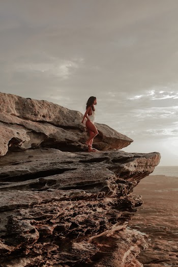 Woman Standing on Rock