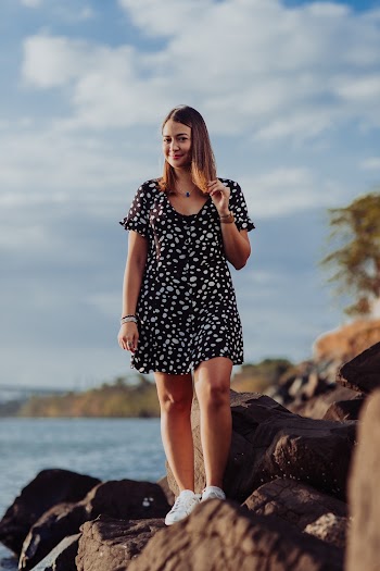 Woman Standing on Rock by the Sea